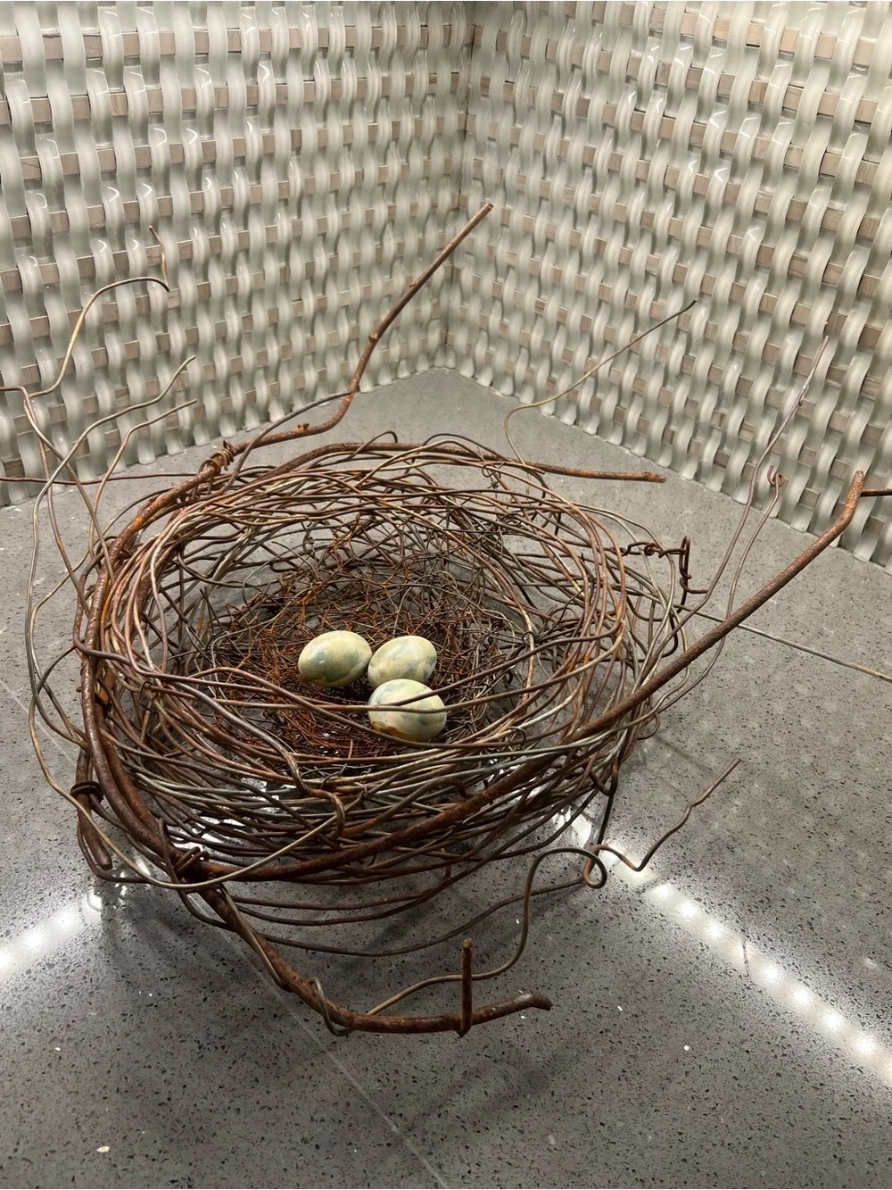 Metal rustic twig nest containing three artificial eggs decorative art